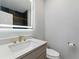 Modern powder room featuring sleek fixtures and unique mirror at 2125 Burnside Nw Dr, Atlanta, GA 30318