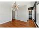 A bedroom featuring hardwood floors, large windows with views, and a modern light fixture at 2125 Burnside Nw Dr, Atlanta, GA 30318