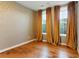 Cozy bedroom with hardwood floors and bright windows draped with gold curtains at 2125 Burnside Nw Dr, Atlanta, GA 30318
