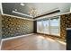 A light-filled bedroom showcases a tray ceiling, unique wallpaper and hardwood floors at 2125 Burnside Nw Dr, Atlanta, GA 30318