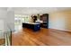 Spacious kitchen with dark cabinets, island with seating, stainless steel appliances, and gleaming hardwood floors at 2125 Burnside Nw Dr, Atlanta, GA 30318