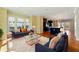 Bright living room featuring hardwood floors, designer wallpaper, and access to a modern kitchen at 2125 Burnside Nw Dr, Atlanta, GA 30318