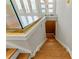 Stairway with modern railing and wooden stairs leading to gold accent wall at 2125 Burnside Nw Dr, Atlanta, GA 30318