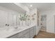 Bright bathroom featuring double sinks, white cabinets, and ample counter space at 2493 Cotton Ln, Douglasville, GA 30135