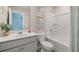 Bright bathroom features a white vanity, toilet, and bathtub with a shower at 2493 Cotton Ln, Douglasville, GA 30135