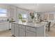 Bright kitchen with white cabinetry, stainless appliances, granite counters, and a view of the living room at 2493 Cotton Ln, Douglasville, GA 30135