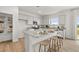 Bright kitchen with white cabinetry, stainless appliances, granite counters, and a center island with seating at 2493 Cotton Ln, Douglasville, GA 30135
