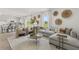 Bright living room with neutral decor, a large sofa, and a view of the kitchen at 2493 Cotton Ln, Douglasville, GA 30135