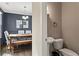 Half bathroom featuring a toilet and pedestal sink located off the dining room at 305 Norwood Ne Ave, Atlanta, GA 30317