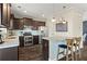 Well-lit kitchen with stainless steel appliances, wood floors, granite countertops, and blue tiled island at 305 Norwood Ne Ave, Atlanta, GA 30317