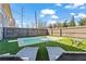 Backyard pool area with lounge chairs, landscaping, and privacy fence creating a relaxing outdoor space at 305 Norwood Ne Ave, Atlanta, GA 30317