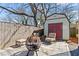 Backyard shed with a fire pit and seating area, perfect for relaxing and enjoying the outdoors at 305 Norwood Ne Ave, Atlanta, GA 30317