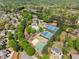 A captivating aerial view showcases a property with tennis courts, pool and clubhouse, a basketball court, and beautifully landscaped surroundings at 6165 Lake Oak Lndg, Cumming, GA 30040