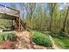 Beautifully landscaped backyard with a stone pathway leading to a cozy outdoor living space at 6165 Lake Oak Lndg, Cumming, GA 30040