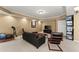 Carpeted basement with dark sofa and media center featuring a drop ceiling at 6165 Lake Oak Lndg, Cumming, GA 30040