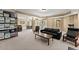 Basement Gathering room with walkout access and drop ceiling and dark furniture at 6165 Lake Oak Lndg, Cumming, GA 30040