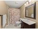 Cozy bathroom featuring a floral shower curtain and wood framed mirror at 6165 Lake Oak Lndg, Cumming, GA 30040