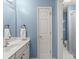 Bathroom featuring white sink and cabinet, a mirror, and tiled floor at 6165 Lake Oak Lndg, Cumming, GA 30040