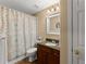 Bathroom features modern vanity, toilet, and shower with stylish curtain at 6165 Lake Oak Lndg, Cumming, GA 30040