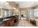 Elegant bathroom with dual sinks, dark cabinetry, a glass shower, soaking tub, and connection to the main bedroom at 6165 Lake Oak Lndg, Cumming, GA 30040