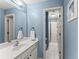 Well-lit bathroom with modern fixtures, a white vanity, and access to a shower at 6165 Lake Oak Lndg, Cumming, GA 30040