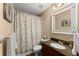Bathroom features modern vanity, toilet, and shower with stylish curtain at 6165 Lake Oak Lndg, Cumming, GA 30040