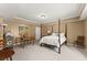 Bedroom with four-poster bed, carpet, drop ceiling, and two chairs at 6165 Lake Oak Lndg, Cumming, GA 30040