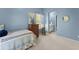 This blue bedroom includes a comfortable bed, windows, and view to en-suite bathroom at 6165 Lake Oak Lndg, Cumming, GA 30040
