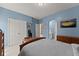 Comfortable bedroom with an attached bathroom featuring wooden furniture and themed decor at 6165 Lake Oak Lndg, Cumming, GA 30040