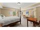 Spacious bedroom featuring carpet, a four poster bed, and multiple windows at 6165 Lake Oak Lndg, Cumming, GA 30040