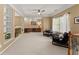Spacious bonus room with built-in shelves, a desk area, ceiling fan, and two rocking chairs at 6165 Lake Oak Lndg, Cumming, GA 30040