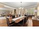 Spacious dining room with large table, stylish lighting, and open view to multiple living areas at 6165 Lake Oak Lndg, Cumming, GA 30040