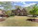 Elegant brick home with well-maintained lawn, mature trees, and inviting curb appeal at 6165 Lake Oak Lndg, Cumming, GA 30040
