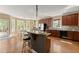 Spacious kitchen features a center island with seating, stainless steel appliances, and hardwood floors at 6165 Lake Oak Lndg, Cumming, GA 30040