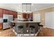 Open kitchen features stainless appliances, granite countertops and bar seating at 6165 Lake Oak Lndg, Cumming, GA 30040