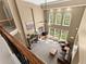 Open-concept living room boasts high ceilings, a fireplace, large windows, and view to the outside at 6165 Lake Oak Lndg, Cumming, GA 30040