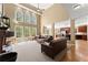 Open-concept living room with vaulted ceilings, large windows, fireplace, and hardwood floors at 6165 Lake Oak Lndg, Cumming, GA 30040