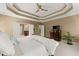 Comfortable main bedroom showcasing a large bed, TV, dresser, and plant, providing a relaxing retreat at 6165 Lake Oak Lndg, Cumming, GA 30040