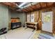 Unfinished basement with storage and workbenches and access to the backyard at 6165 Lake Oak Lndg, Cumming, GA 30040