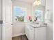 Bright bathroom features a granite countertop, wood-look floors, and natural light from the window at 11841 Rizvan Pl, Covington, GA 30014