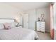 Charming bedroom with neutral walls, carpet, a plush bed, a large window, and a stylish dresser at 11841 Rizvan Pl, Covington, GA 30014