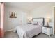 Comfortable bedroom with nightstands, plush carpet and a queen size bed with soft, neutral bedding at 11841 Rizvan Pl, Covington, GA 30014