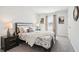 Bright bedroom with neutral décor, bedside tables, and natural light from the window at 11841 Rizvan Pl, Covington, GA 30014