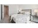 Well-lit bedroom with stylish furniture, neutral tones, and easy access to the ensuite bathroom at 11841 Rizvan Pl, Covington, GA 30014