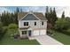 Charming two-story home with two-car garage and beautifully landscaped front yard at 11841 Rizvan Pl, Covington, GA 30014