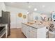 Spacious kitchen featuring a central island with granite countertops, stainless appliances, and seating area at 11841 Rizvan Pl, Covington, GA 30014