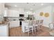 Modern kitchen with white cabinets, granite countertops, stainless steel appliances, and a breakfast bar with seating at 11841 Rizvan Pl, Covington, GA 30014