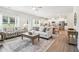 Open-concept living room showcasing seamless flow into the kitchen and dining area at 11841 Rizvan Pl, Covington, GA 30014