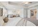 Bright main bedroom features a tray ceiling, neutral paint, and sitting area at 11841 Rizvan Pl, Covington, GA 30014