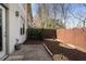 A cozy backyard featuring a patio area, wooden fence and mulched garden beds at 1342 Rietveld Nw Row, Atlanta, GA 30318